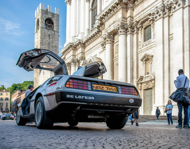 The historic Mille Miglia car race. The real DMC DeLorean 1981 on the Duomo square in Brescia 1000 Miglia 2018, Brescia - Italy. May 19, 2018: The historic Mille Miglia car race. The real DMC DeLorean 1981 on the Duomo square in Brescia life stile stock pictures, royalty-free photos & images