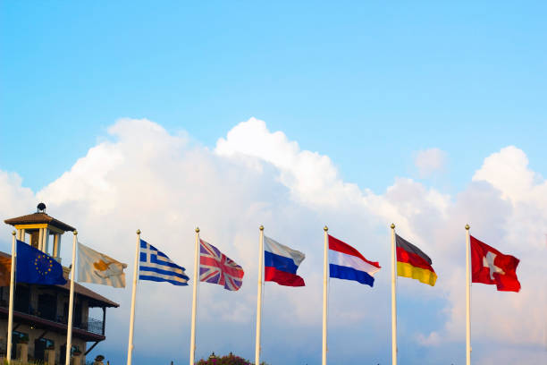 istock Flags of different countries flapping in wind against blue sky 1091344100