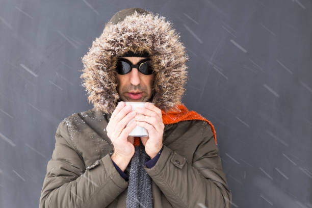 istock Freezing winter adventurer drinking from a metal cup 1091345454