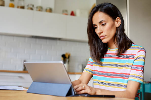 istock Beautiful mid adult woman using digital tablet 1091346240