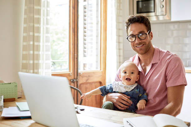istock Portrait of father and son with laptop at table 1091346310