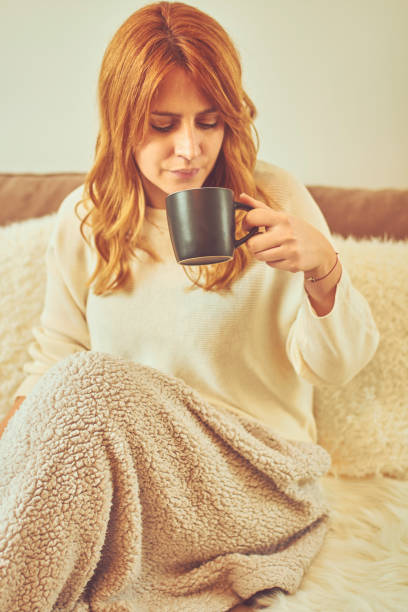 istock Beautiful woman drinking coffee in her bed and using cellphone. 1091349488