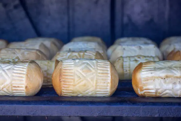 Photo of The polisch cheese specialty oscypek is cured and smoked in a wood hut for the final stage of the processing.