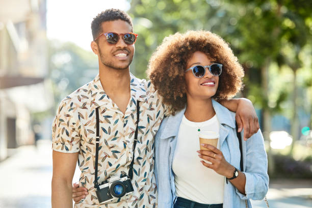 istock Tourists walking arm around on sidewalk in city 1091357862