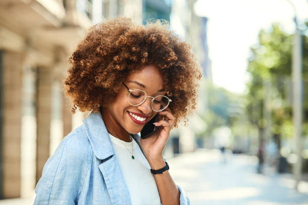 istock Shy female talking on mobile phone at sidewalk 1091357908