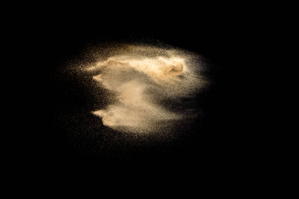 istock Golden sand explosion isolated on black background. Abstract sand cloud. Golden colored sand splash against dark background. Yellow sand fly wave in the air. 1091358322