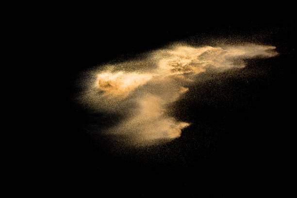 istock Golden sand explosion isolated on black background. Abstract sand cloud. Golden colored sand splash against dark background. Yellow sand fly wave in the air. 1091358340