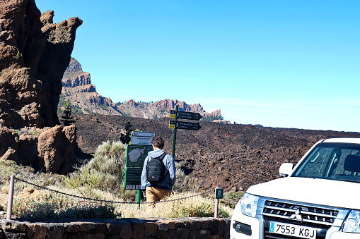 El Teide National Park, Tenerife / Spain - December 21, 2018 : Information signs at the foot of the Teide volcano, which indicate the direction for hiking trails