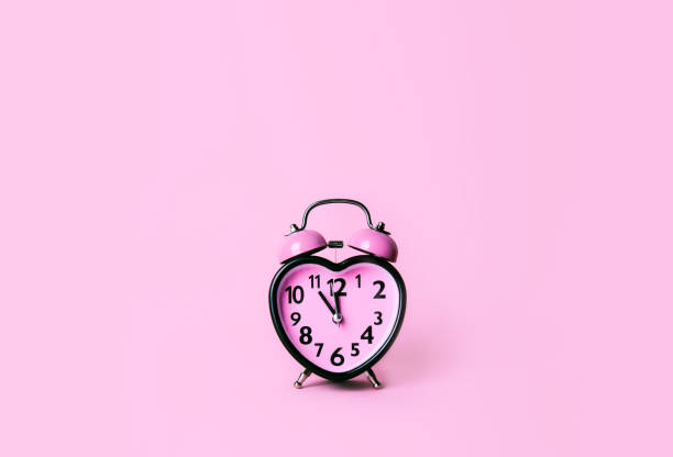 istock Heart shaped clock on pink background. Valentines day and love and duration concept. 1091363892