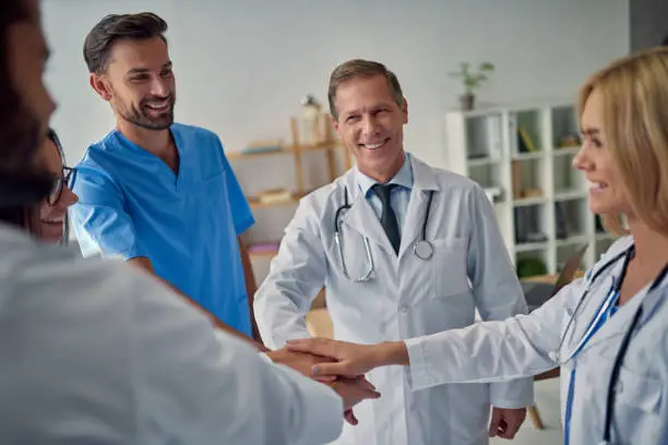 Group of doctors working together in clinic. Medical personnel in uniform.