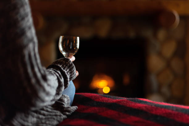 romantic fireplace with glass of wine - rustic bedroom cabin indoors imagens e fotografias de stock