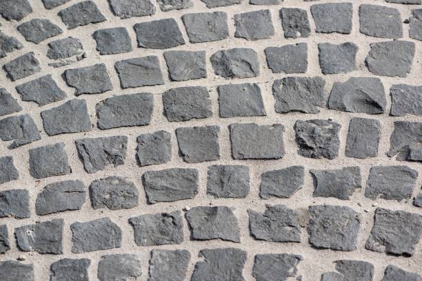 istock Abstract background of old cobblestone pavement view from above 1091365426