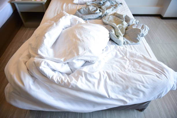istock Pajamas with Unmade bed with messy blankets, Busy mattress . 1091369626