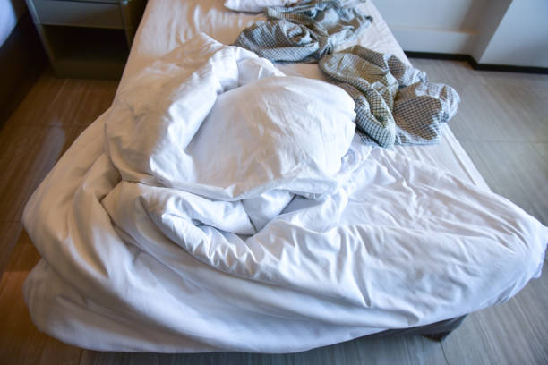 istock Pajamas with Unmade bed with messy blankets, Busy mattress . 1091369704