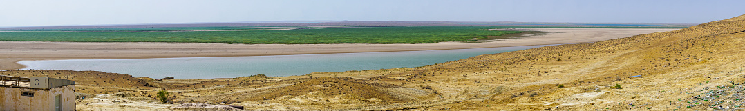 Panorama View from view point between Khiva and Bokhara in Uzbekistan, at Kara Kum desert and Lake in Turkmenistan on the hat morning day.