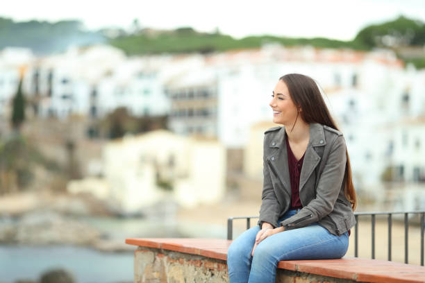 istock Relaxed woman contemlating views in a coast town 1091380988