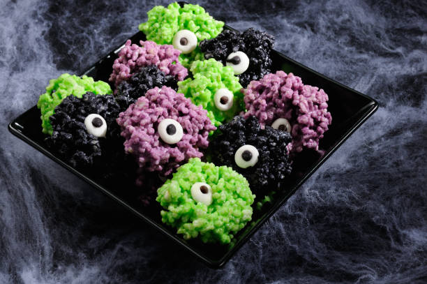 Monsters eye balls- made from marshmallows Rice krispies bites crispy bite balls. These are delicious, delight have a creepy monster and funny colors of Halloween