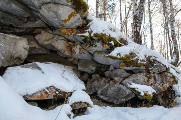 istock in the Ural mountains, in the forest, stone, moss, snow. 1091383914