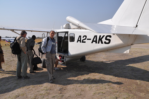 Kasane, Botswana - August, 24, 2013: Group of tourists arriving in the airstrip