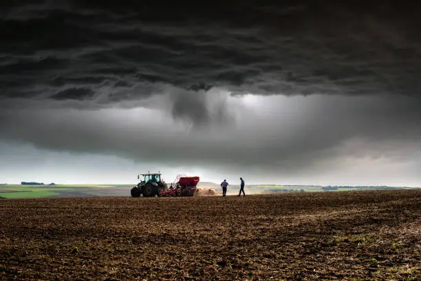 Photo of Farmer at work under storm