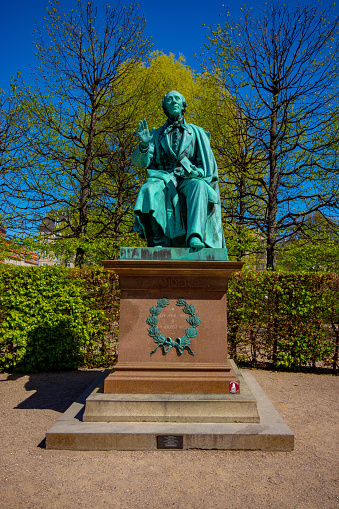 Rosenborg Castle grounds in central Copenhagen, Denmark, the castle was built and extended between 1606 and 1633 in Dutch renaissance style by King Christian IV. This image is in the ornamental gardens with a statue of Hans Christian Anderson which is dated early 19th Century.  The garden and the statues within it are mainly17th and 18th century in origin.