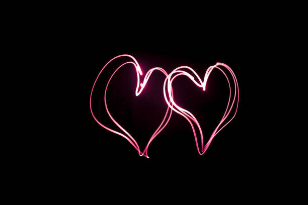istock Light Painting, Two red hearts, long exposure 1091388606