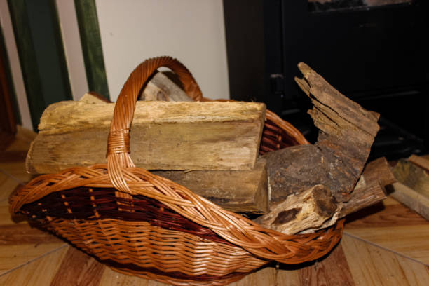 istock Firewood in a wicker basket ready to set on fire. 1091392456