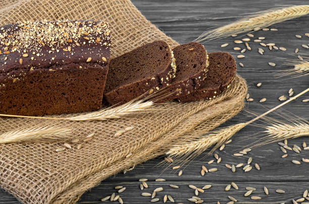 istock Rye bread and ears of rye on wooden table 1091395280