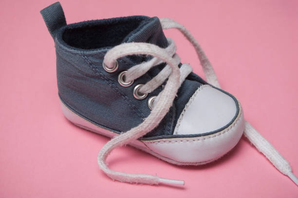 istock blue baby sneaker on pink background 1091397062