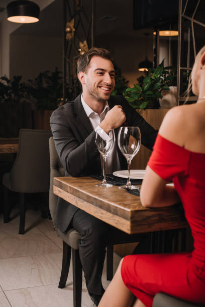 istock handsome boyfriend looking and smiling at girlfriend in red dress 1091397708