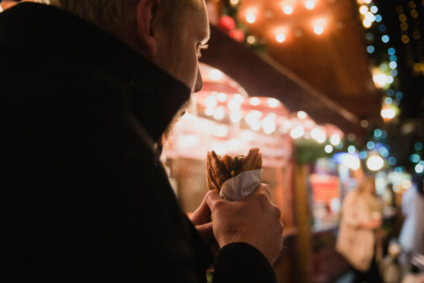 istock Man Eating Street Food 1091400114