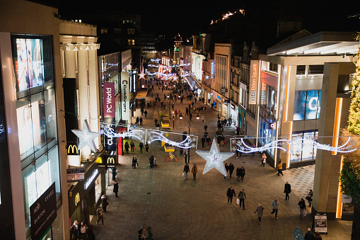 A high-angle view of a busy high street near Christmas time, people can be seen completing their Christmas shopping on a dark night in Newcastle, England.
