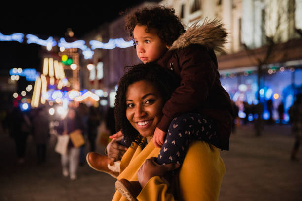 istock Little Girl Sitting on Mummy's Shoulders 1091400954