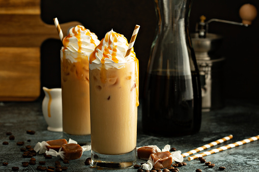 Caramel iced latte with whipped cream and syrup