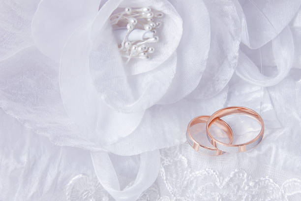 istock Wedding rings on wedding card, on a white wedding dress 1091403528