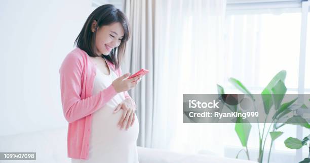 Pregnant Woman Use Smart Phone Stock Photo - Download Image Now - Pregnant, Asia, Mobile Phone