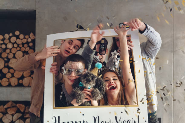 Group of friends posing together in a photo booth, smiling and enjoying the moment