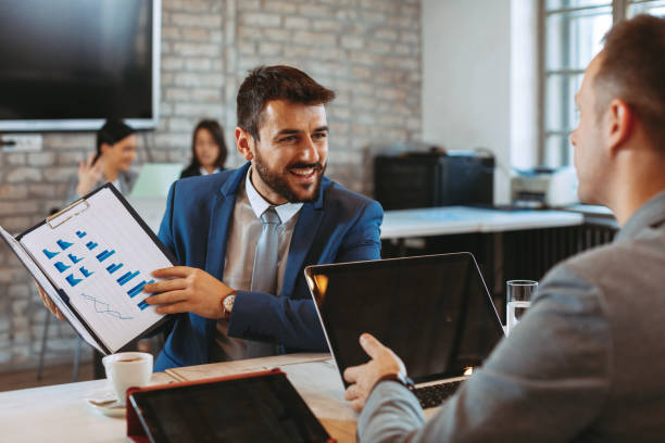 istock Two young businessmen interacting at meeting in office 1091407552
