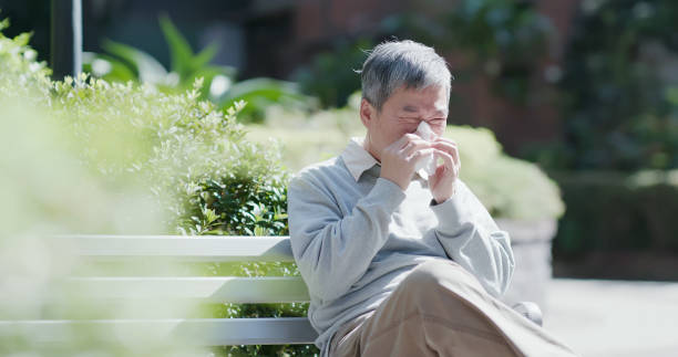 old man sick and sneeze stock photo