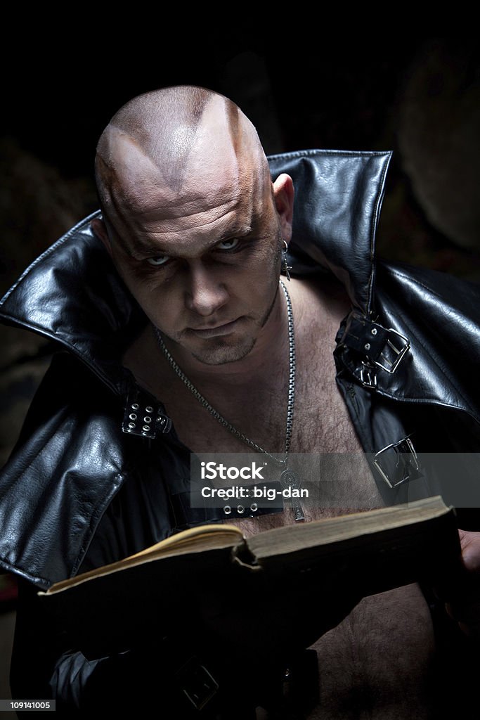 Black Magician Black Magician in the leather raincoat is looking on you. Adult Stock Photo