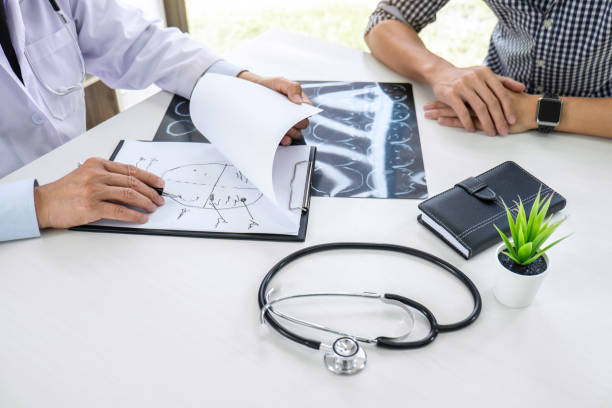 istock Professor Doctor having conversation with patient and holding x-ray film while discussing explaining symptoms or counsel diagnosis health, healthcare and assistance concept 1091423734