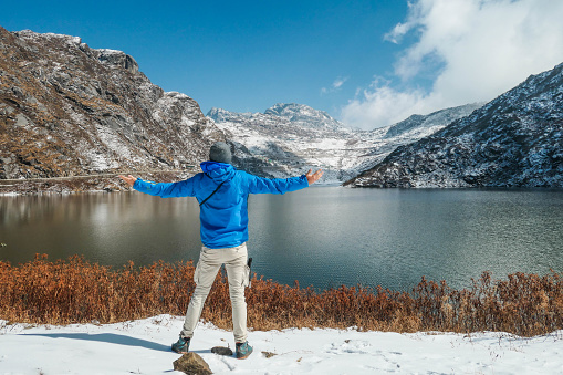 A boy enjoying the view to Tsomgo Lake in North Sikkim. Just above the mountains is Tibet.