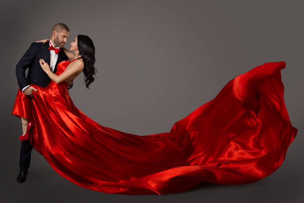 Dancing Couple Woman In Red Dress And Elegant Man In Suit Flying Waving  Fabric Stock Photo - Download Image Now - iStock