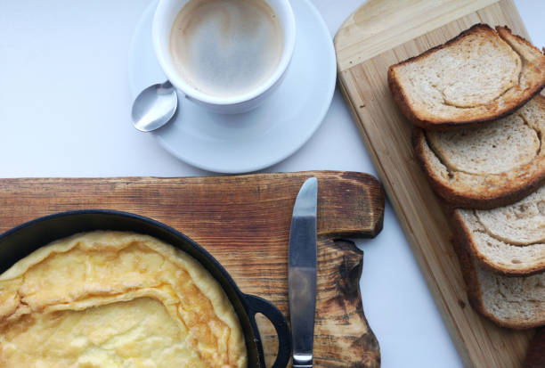 Country Food. Delicious breakfast: coffee, croutons, scrambled eggs in a pan.