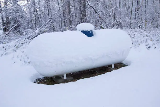 Propane tank covered in snow on a frigid winter day in northern Michigan.