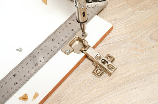 istock Installing and fixing furniture hinges with a screwdriver on the screws. 1091434134