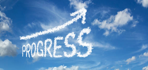 istock PROGRESS inscription with arrows on a blue sky with clouds 1091434264