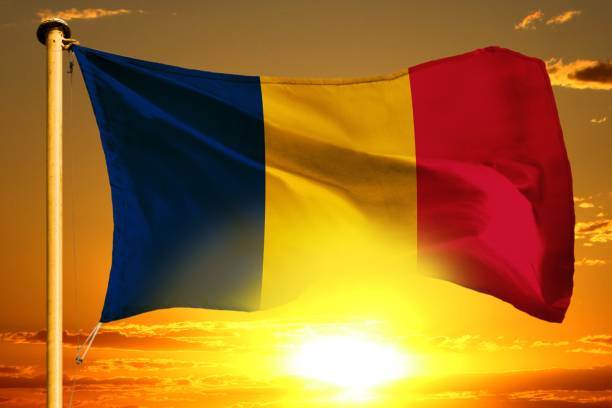 istock Chad flag weaving on the beautiful orange sunset with clouds background 1091435648