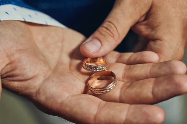 istock man holding wedding rings, groom getting ready in the morning before ceremony 1091436556