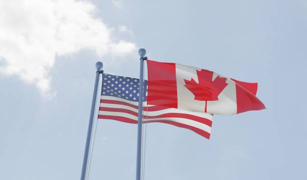 istock USA and Canada, two flags waving against blue sky 1091438630